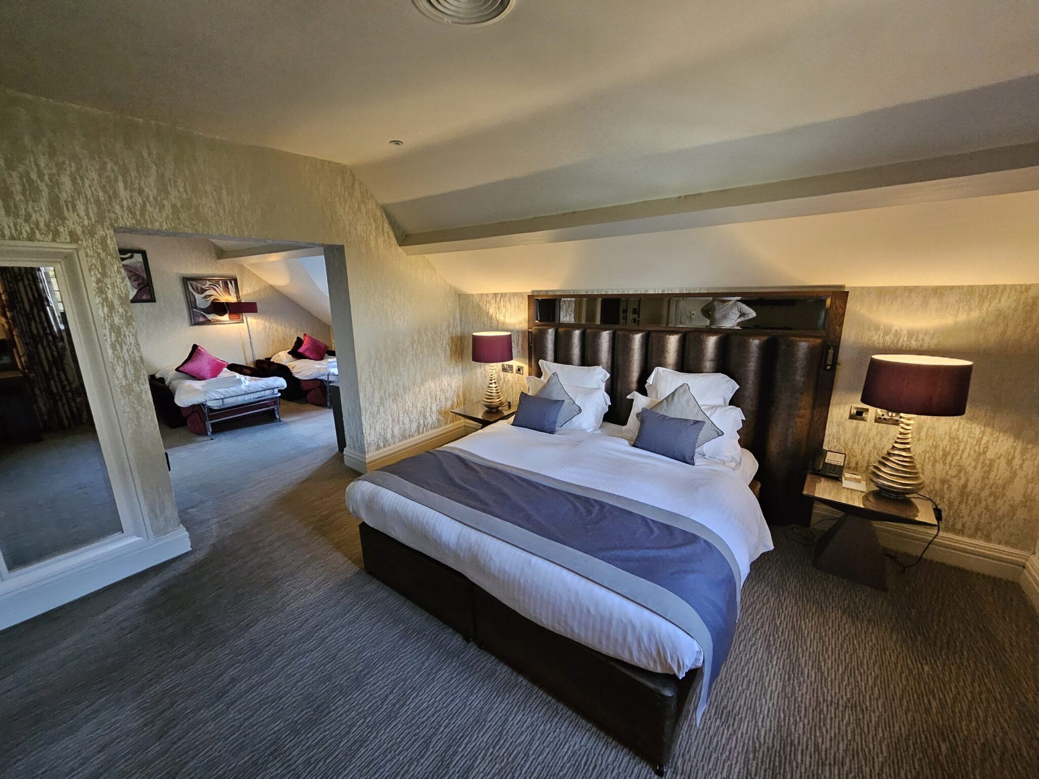 Family bedroom at the Grosvenor Pulford Hotel & Spa with king-size bed and sofa bed area